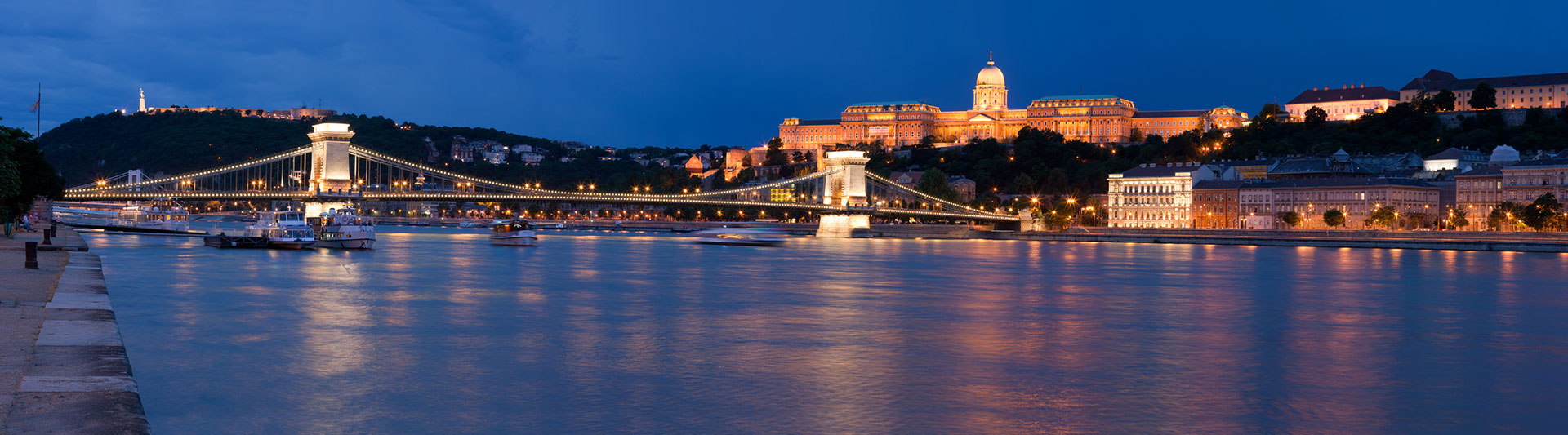 Chain Bridge and Buda Castle lit up at night over the Danube in Budapest