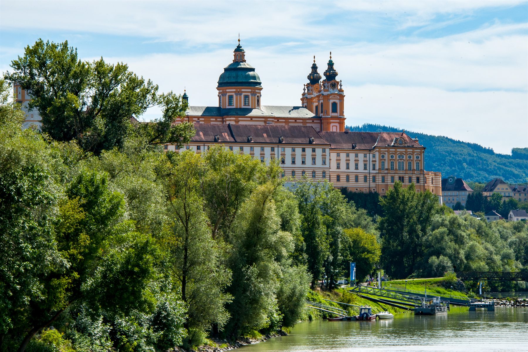 Melk Abbey rising above the trees on the banks of the Danube